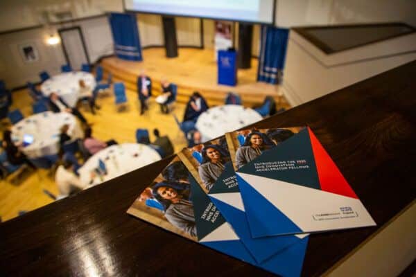 A room with people sitting at cabaret tables